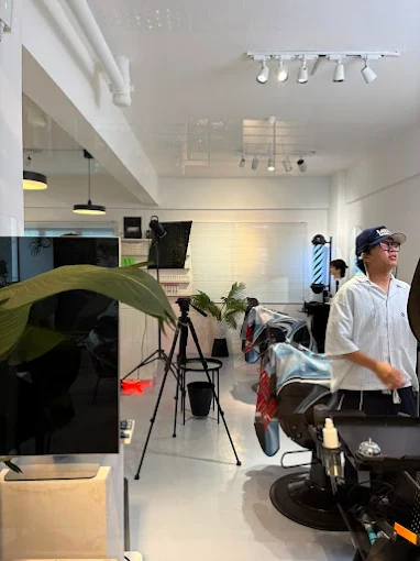 Inside The Brozkey Club with mirrors, plants and barber chairs
