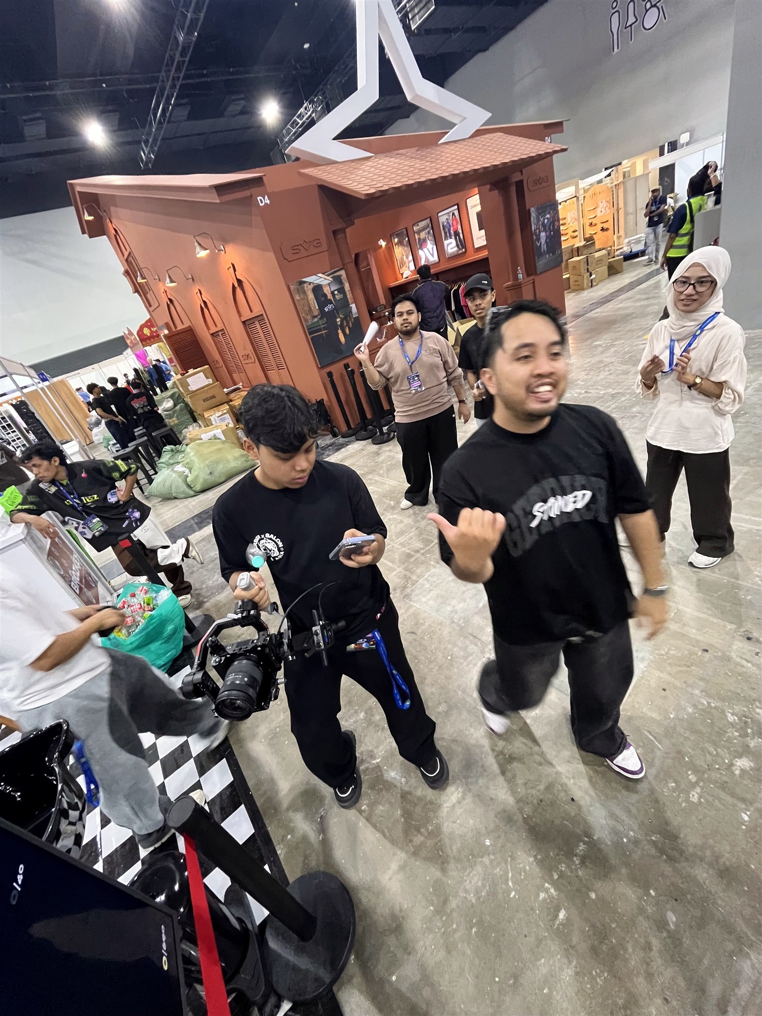 The team with camera equipment in the exhibition hall