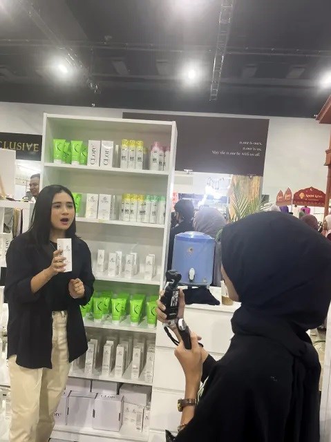 A product demonstration being filmed in front of the display shelves